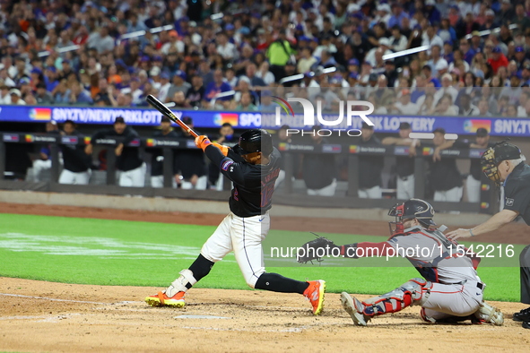 Francisco Lindor #12 of the New York Mets singles during the fourth inning of the baseball game against the Boston Red Sox at Citi Field in...