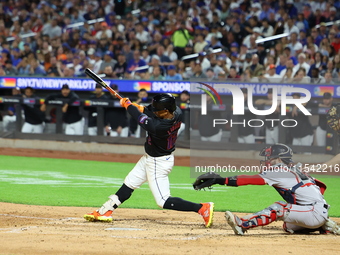 Francisco Lindor #12 of the New York Mets singles during the fourth inning of the baseball game against the Boston Red Sox at Citi Field in...