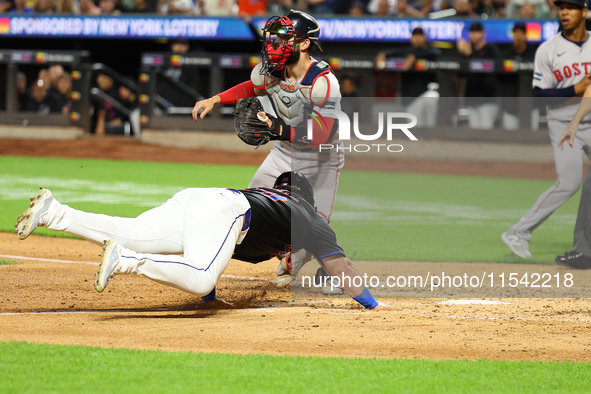 New York Mets DJ Stewart #29 scores from 2B during the fourth inning of the baseball game against the Boston Red Sox at Citi Field in Corona...