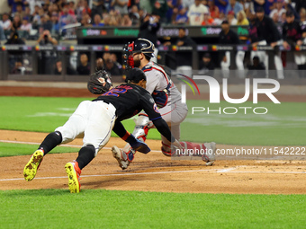 Francisco Lindor #12 of the New York Mets scores from second base during the third inning of the baseball game against the Boston Red Sox at...