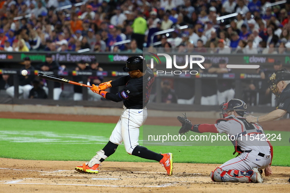 Francisco Lindor #12 of the New York Mets singles during the third inning of the baseball game against the Boston Red Sox at Citi Field in C...