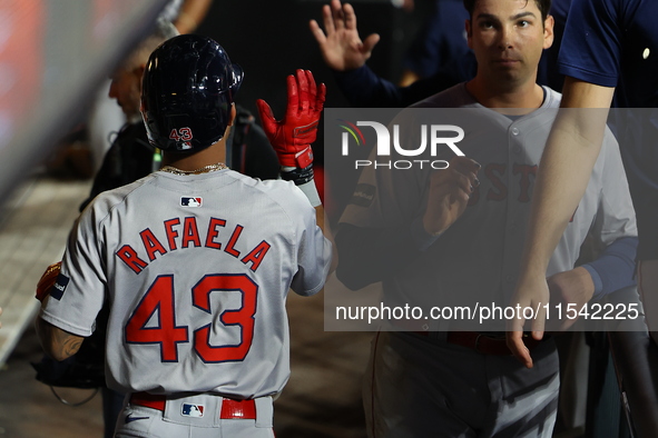 Boston Red Sox player Ceddanne Rafaela #43 is congratulated after scoring during the third inning of the baseball game against the New York...