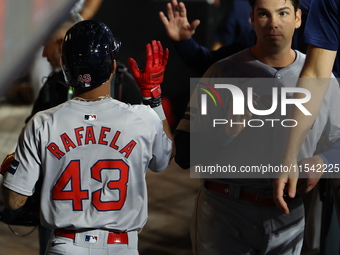 Boston Red Sox player Ceddanne Rafaela #43 is congratulated after scoring during the third inning of the baseball game against the New York...