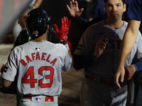 Boston Red Sox player Ceddanne Rafaela #43 is congratulated after scoring during the third inning of the baseball game against the New York...