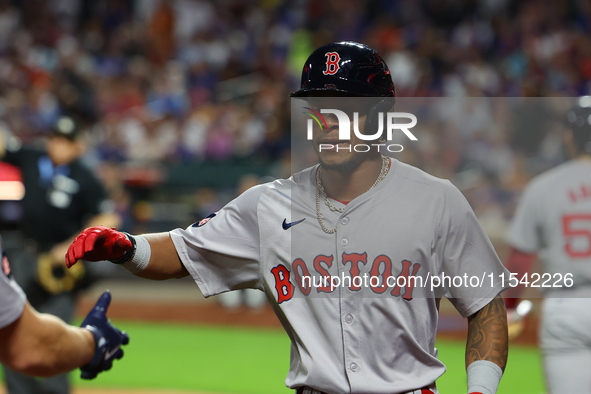 Boston Red Sox player Ceddanne Rafaela #43 is congratulated after scoring during the third inning of the baseball game against the New York...