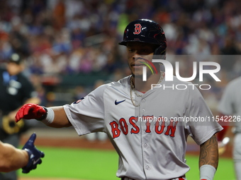 Boston Red Sox player Ceddanne Rafaela #43 is congratulated after scoring during the third inning of the baseball game against the New York...