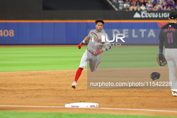 Ceddanne Rafaela #43 of the Boston Red Sox triples during the third inning of the baseball game against the New York Mets at Citi Field in C...