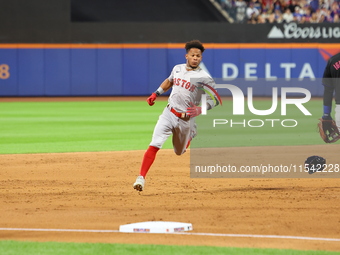 Ceddanne Rafaela #43 of the Boston Red Sox triples during the third inning of the baseball game against the New York Mets at Citi Field in C...