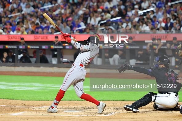 Ceddanne Rafaela #43 of the Boston Red Sox triples during the third inning of the baseball game against the New York Mets at Citi Field in C...