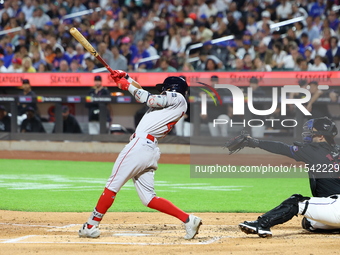 Ceddanne Rafaela #43 of the Boston Red Sox triples during the third inning of the baseball game against the New York Mets at Citi Field in C...