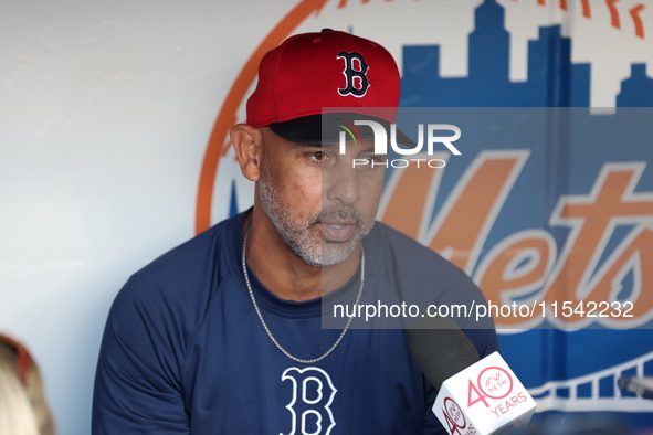 Boston Red Sox manager Alex Cora speaks to the media in the dugout before the baseball game against the New York Mets at Citi Field in Coron...