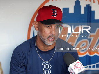 Boston Red Sox manager Alex Cora speaks to the media in the dugout before the baseball game against the New York Mets at Citi Field in Coron...