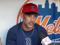 Boston Red Sox manager Alex Cora speaks to the media in the dugout before the baseball game against the New York Mets at Citi Field in Coron...