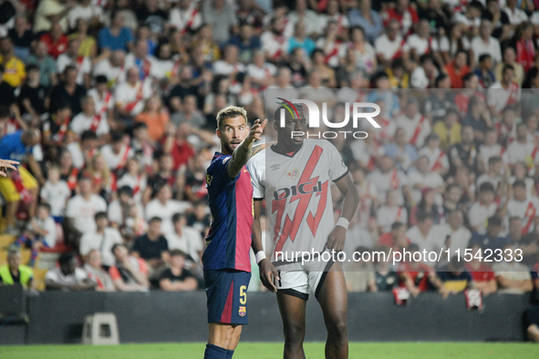 Inigo Martinez of Barcelona faces Nteka of Rayo Vallecano during the La Liga match between Rayo Vallecano and FC Barcelona at Estadio de Val...