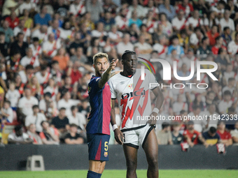 Inigo Martinez of Barcelona faces Nteka of Rayo Vallecano during the La Liga match between Rayo Vallecano and FC Barcelona at Estadio de Val...