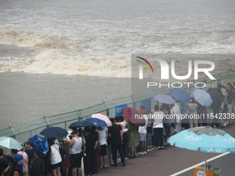 Tourists watch the spring tide of the Qiantang River along the river in Hangzhou, Zhejiang province, China, on September 3, 2024. (