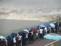 Tourists watch the spring tide of the Qiantang River along the river in Hangzhou, Zhejiang province, China, on September 3, 2024. (