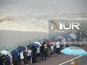 Tourists watch the spring tide of the Qiantang River along the river in Hangzhou, Zhejiang province, China, on September 3, 2024. (