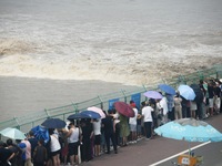 Tourists watch the spring tide of the Qiantang River along the river in Hangzhou, Zhejiang province, China, on September 3, 2024. (