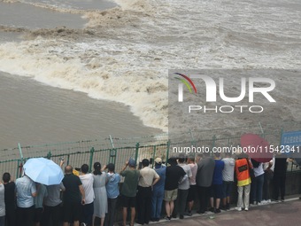 Tourists watch the spring tide of the Qiantang River along the river in Hangzhou, Zhejiang province, China, on September 3, 2024. (