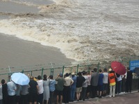 Tourists watch the spring tide of the Qiantang River along the river in Hangzhou, Zhejiang province, China, on September 3, 2024. (