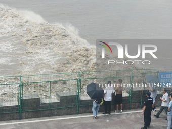 Tourists watch the spring tide of the Qiantang River along the river in Hangzhou, Zhejiang province, China, on September 3, 2024. (