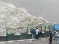 Tourists watch the spring tide of the Qiantang River along the river in Hangzhou, Zhejiang province, China, on September 3, 2024. (