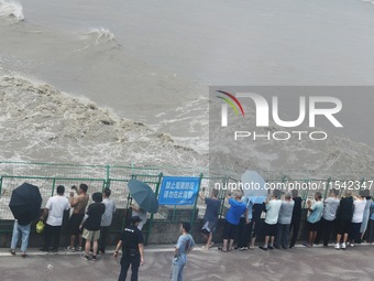 Tourists watch the spring tide of the Qiantang River along the river in Hangzhou, Zhejiang province, China, on September 3, 2024. (