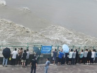 Tourists watch the spring tide of the Qiantang River along the river in Hangzhou, Zhejiang province, China, on September 3, 2024. (