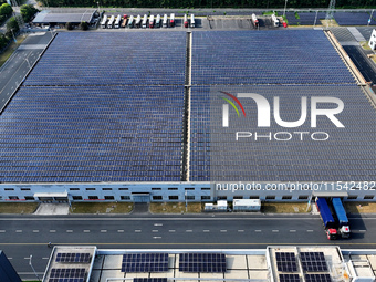 Rows of photovoltaic panels are seen on top of a New Materials company house in Haian, China, on September 3, 2024. (