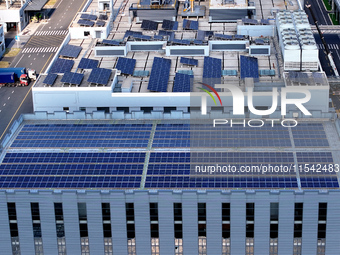 Rows of photovoltaic panels are seen on top of a New Materials company house in Haian, China, on September 3, 2024. (