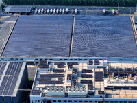 Rows of photovoltaic panels are seen on top of a New Materials company house in Haian, China, on September 3, 2024. (