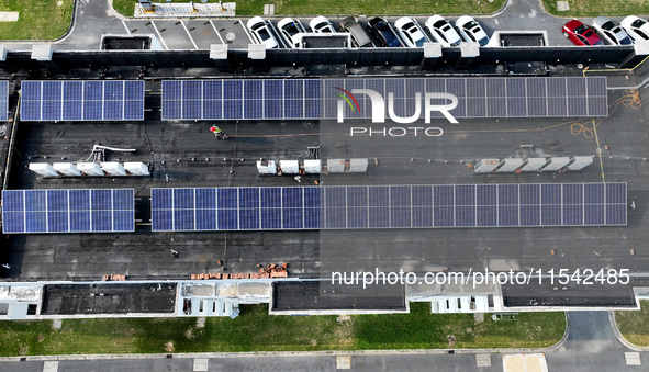 Rows of photovoltaic panels are seen on top of a New Materials company house in Haian, China, on September 3, 2024. 