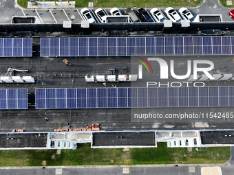 Rows of photovoltaic panels are seen on top of a New Materials company house in Haian, China, on September 3, 2024. (