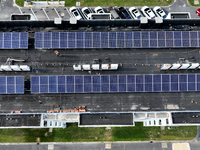 Rows of photovoltaic panels are seen on top of a New Materials company house in Haian, China, on September 3, 2024. (