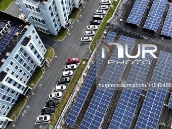 Rows of photovoltaic panels are seen on top of a New Materials company house in Haian, China, on September 3, 2024. (