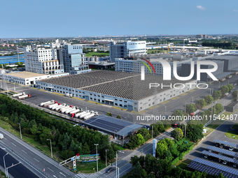 Rows of photovoltaic panels are seen on top of a New Materials company house in Haian, China, on September 3, 2024. (