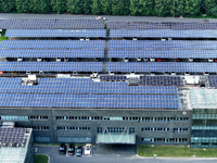 Rows of photovoltaic panels are seen on top of a New Materials company house in Haian, China, on September 3, 2024. (