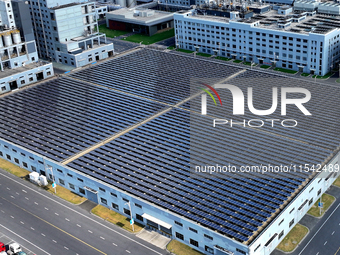 Rows of photovoltaic panels are seen on top of a New Materials company house in Haian, China, on September 3, 2024. (