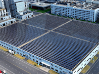 Rows of photovoltaic panels are seen on top of a New Materials company house in Haian, China, on September 3, 2024. (