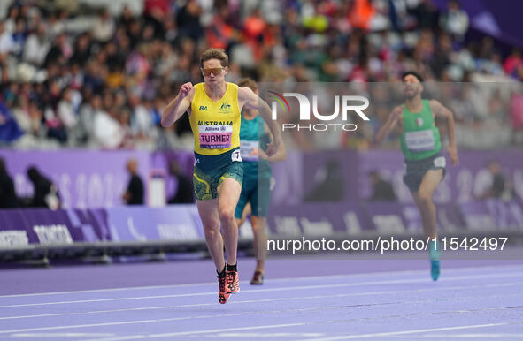 James Turner of Australia celebrates winning gold in Men's 400m - T36 Final during the Paris 2024 Paralympic Games at Stade de France on Sep...