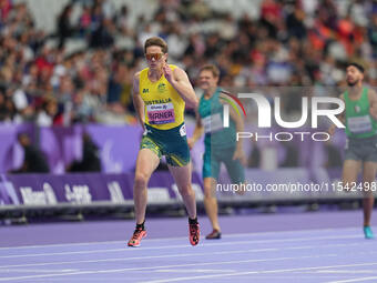 James Turner of Australia celebrates winning gold in Men's 400m - T36 Final during the Paris 2024 Paralympic Games at Stade de France on Sep...