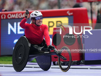 Catherine Debrunner of Switzerland celebrates winning gold in Women's 1500m - T54 Final during the Paris 2024 Paralympic Games at Stade de F...