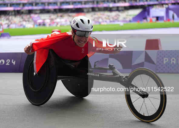 Catherine Debrunner of Switzerland celebrates winning gold in Women's 1500m - T54 Final during the Paris 2024 Paralympic Games at Stade de F...