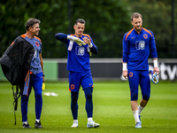 Netherlands goalkeeper trainer Patrick Lodewijks, Netherlands goalkeeper Nick Olij, and Netherlands goalkeeper Mark Flekken during the train...