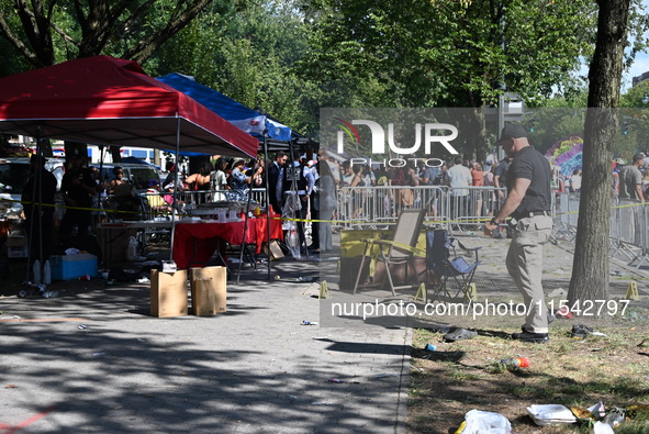 View of the crime scene with evidence markers placed on the ground. The NYPD says in an update that one person is killed and four other peop...