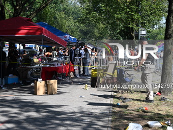 View of the crime scene with evidence markers placed on the ground. The NYPD says in an update that one person is killed and four other peop...