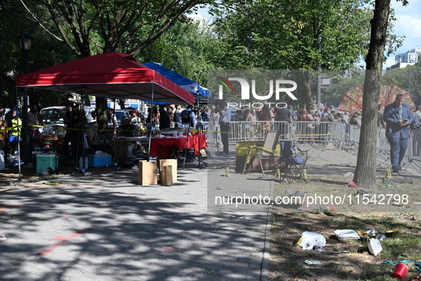 View of the crime scene with evidence markers placed on the ground. The NYPD says in an update that one person is killed and four other peop...