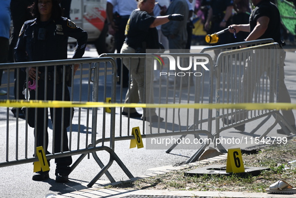 View of the crime scene with evidence markers placed on the ground. The NYPD says in an update that one person is killed and four other peop...