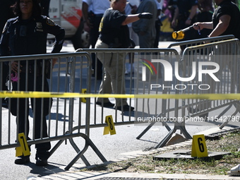 View of the crime scene with evidence markers placed on the ground. The NYPD says in an update that one person is killed and four other peop...